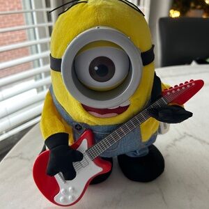 Yellow and Blue Stuffed Minion Toy with Red Guitar